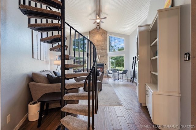 56901 E Walnut, Monkey Island, OK 74331 - stairs featuring ceiling fan, wood finished floors, a fireplace, high vaulted ceiling, and beam ceiling