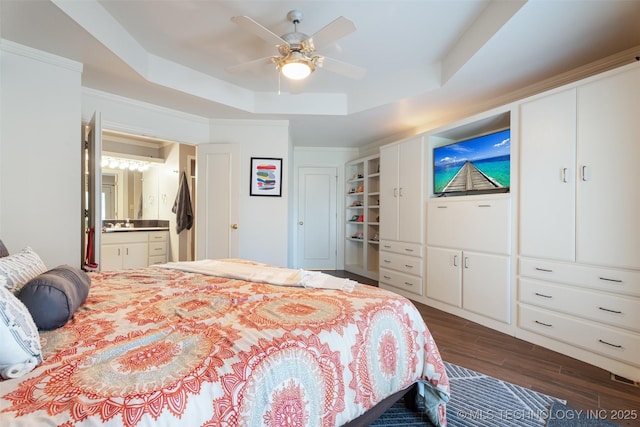 56901 E Walnut, Monkey Island, OK 74331 - bedroom featuring dark wood-style flooring, a raised ceiling, ensuite bath, and a ceiling fan