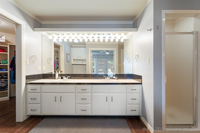 56901 E Walnut, Monkey Island, OK 74331 - full bathroom with a spacious closet, wood finished floors, double vanity, a shower stall, and ceiling fan