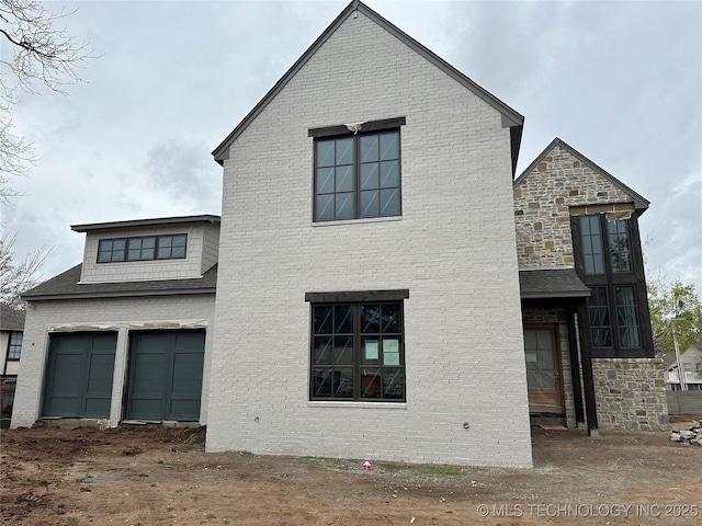 1245 E 28th St, Tulsa, OK 74114 - view of property exterior featuring a garage and stone siding