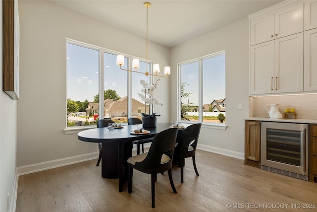 7221 E Norman St, Broken Arrow, OK 74014 - dining area featuring beverage cooler, plenty of natural light, and light wood-style flooring