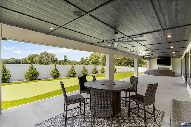 7221 E Norman St, Broken Arrow, OK 74014 - fenced backyard featuring a putting area, a patio, ceiling fan, and outdoor dining area