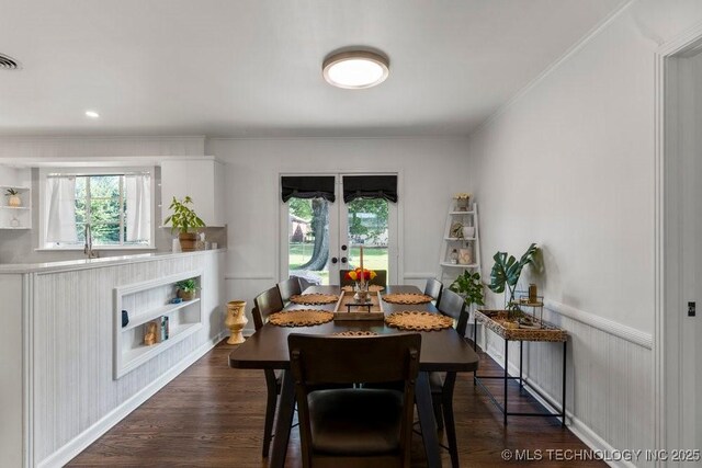 4331 E 28th St, Tulsa, OK 74114 - dining room with crown molding, french doors, dark wood-style floors, and a wainscoted wall