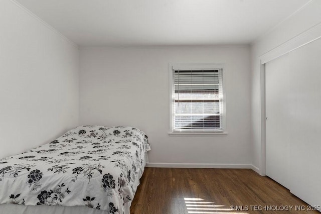 4331 E 28th St, Tulsa, OK 74114 - bedroom featuring wood finished floors, crown molding, and a closet