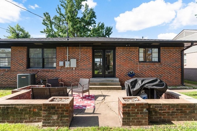 4331 E 28th St, Tulsa, OK 74114 - rear view of property featuring a fire pit, brick siding, a patio, and entry steps