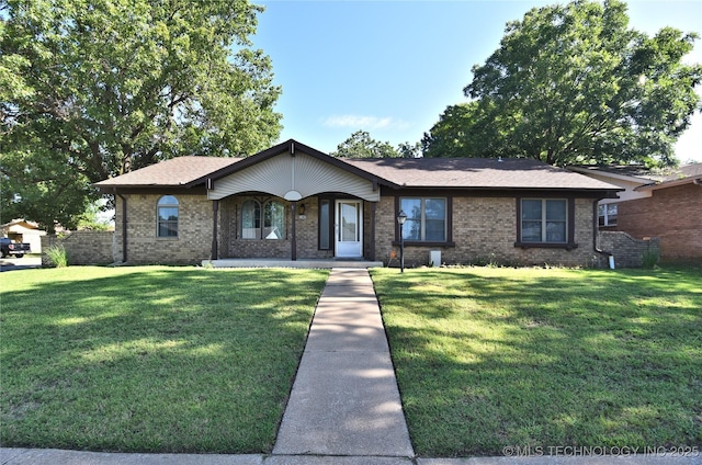 11003 E 27th St, Tulsa, OK 74129 - view of front facade featuring brick siding, a front yard, and covered porch