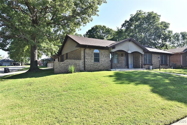 11003 E 27th St, Tulsa, OK 74129 - view of front of home featuring brick siding, a front yard, and a porch