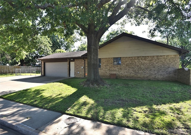 11003 E 27th St, Tulsa, OK 74129 - ranch-style home with brick siding, an attached garage, and driveway
