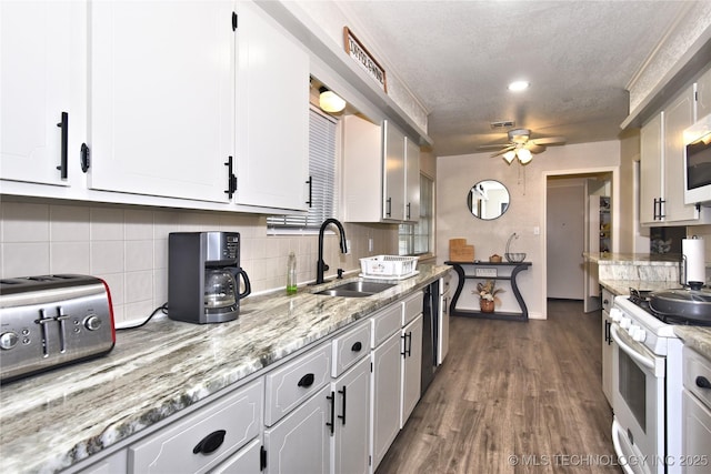 11003 E 27th St, Tulsa, OK 74129 - kitchen with white appliances, a ceiling fan, white cabinets, tasteful backsplash, and dark wood finished floors