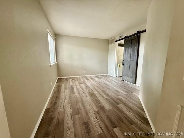 1730 E 67th St Unit K104, Tulsa, OK 74136 - unfurnished room with wood finished floors and a barn door