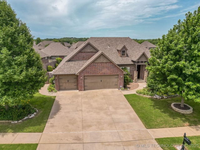 9314 N 96th E Ave, Owasso, OK 74055 - view of front of home with brick siding, an attached garage, a front yard, concrete driveway, and a shingled roof