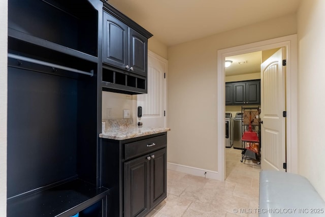9314 N 96th E Ave, Owasso, OK 74055 - laundry area featuring washer and dryer, cabinet space, and light tile patterned floors