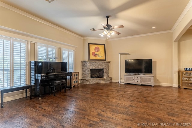 9314 N 96th E Ave, Owasso, OK 74055 - living room featuring ceiling fan, a stone fireplace, crown molding, wood finished floors, and arched walkways