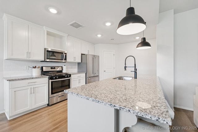 9423 E 132nd Pl S, Bixby, OK 74008 - kitchen with appliances with stainless steel finishes, light wood-type flooring, white cabinets, and recessed lighting
