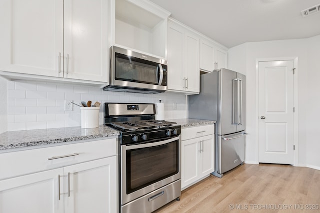 9423 E 132nd Pl S, Bixby, OK 74008 - kitchen with stainless steel appliances, light wood-style floors, white cabinetry, backsplash, and light stone countertops