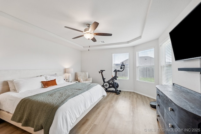 9423 E 132nd Pl S, Bixby, OK 74008 - bedroom featuring a raised ceiling, wood finished floors, and ceiling fan