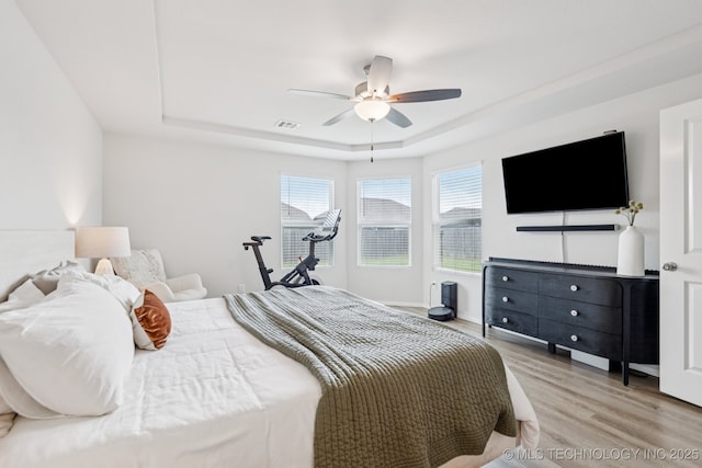9423 E 132nd Pl S, Bixby, OK 74008 - bedroom with a raised ceiling, light wood-type flooring, and ceiling fan