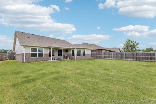 9423 E 132nd Pl S, Bixby, OK 74008 - rear view of house featuring brick siding, a patio, a fenced backyard, and roof with shingles