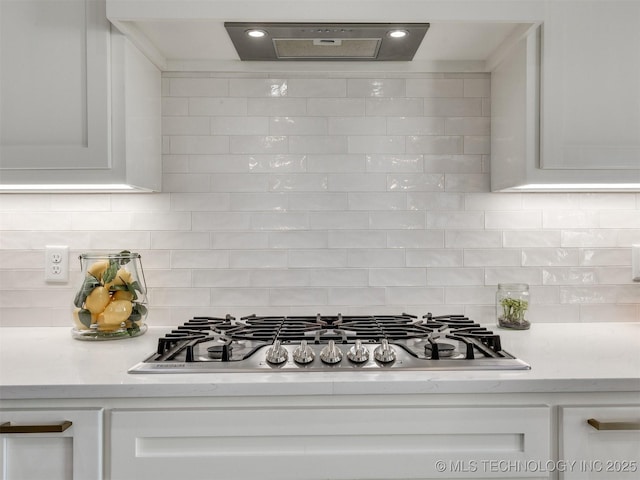 13642 S 21st Pl E, Bixby, OK 74008 - kitchen with stainless steel gas stovetop, exhaust hood, light countertops, and white cabinets