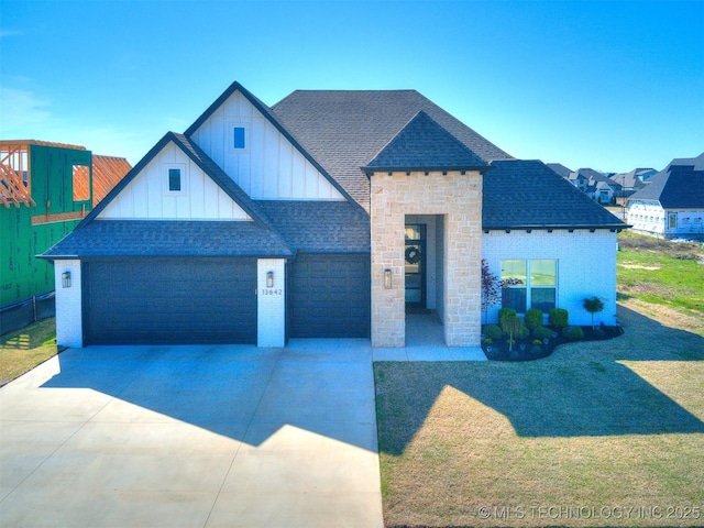 13642 S 21st Pl E, Bixby, OK 74008 - view of front of home featuring a shingled roof, board and batten siding, driveway, a front yard, and a garage