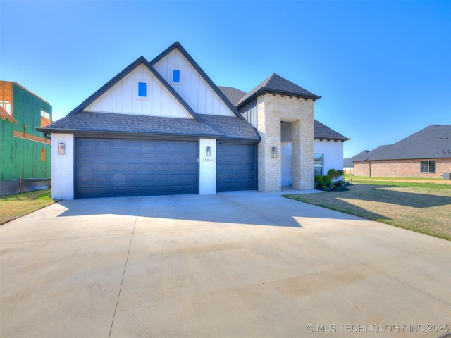 13642 S 21st Pl E, Bixby, OK 74008 - view of front of property with board and batten siding, driveway, brick siding, and an attached garage