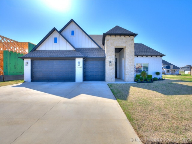 13642 S 21st Pl E, Bixby, OK 74008 - view of front of property with board and batten siding, a front yard, a garage, concrete driveway, and roof with shingles
