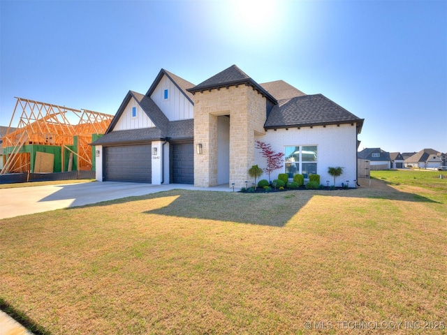 13642 S 21st Pl E, Bixby, OK 74008 - view of front of house with board and batten siding, concrete driveway, a garage, a front lawn, and roof with shingles