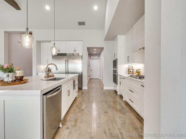 13642 S 21st Pl E, Bixby, OK 74008 - kitchen with built in appliances, light countertops, white cabinetry, light wood-style floors, and recessed lighting