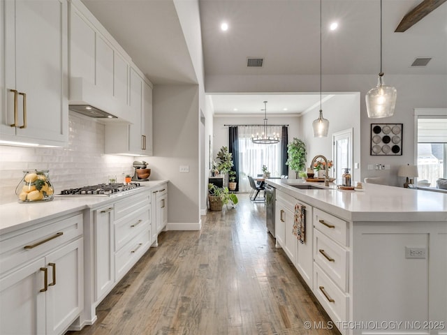 13642 S 21st Pl E, Bixby, OK 74008 - kitchen featuring stainless steel gas cooktop, extractor fan, healthy amount of natural light, backsplash, and recessed lighting