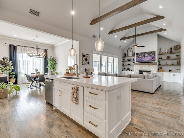 13642 S 21st Pl E, Bixby, OK 74008 - kitchen featuring stainless steel dishwasher, beam ceiling, a stone fireplace, healthy amount of natural light, and light wood-style flooring