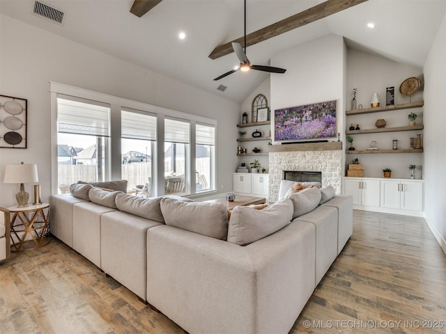 13642 S 21st Pl E, Bixby, OK 74008 - living area featuring a ceiling fan, wood finished floors, a stone fireplace, beamed ceiling, and high vaulted ceiling