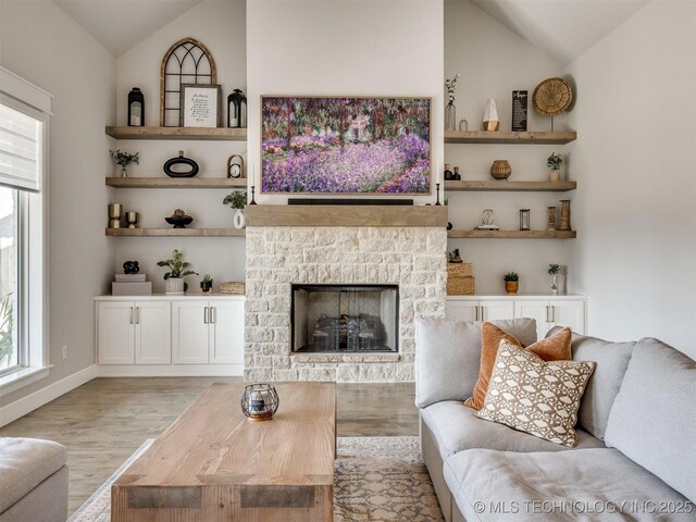 13642 S 21st Pl E, Bixby, OK 74008 - living room with lofted ceiling, wood finished floors, and a stone fireplace