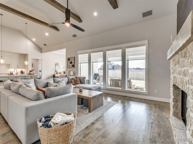13642 S 21st Pl E, Bixby, OK 74008 - living room with high vaulted ceiling, beam ceiling, a fireplace, a ceiling fan, and wood finished floors