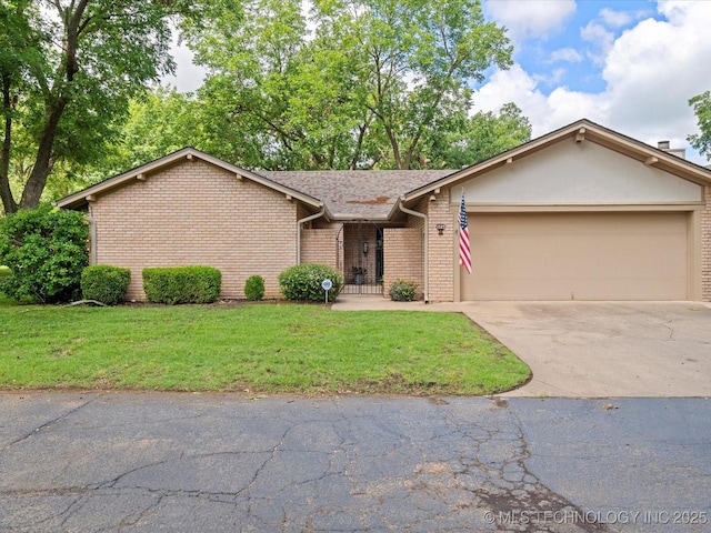 1525 Pecan Pl, Bartlesville, OK 74003 - view of front of home with driveway, an attached garage, brick siding, and a front lawn