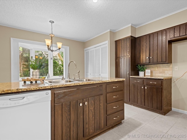 1525 Pecan Pl, Bartlesville, OK 74003 - kitchen featuring white dishwasher, a chandelier, a textured ceiling, pendant lighting, and backsplash