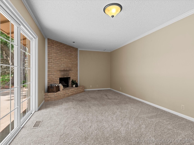 1525 Pecan Pl, Bartlesville, OK 74003 - unfurnished living room with a textured ceiling, carpet flooring, a brick fireplace, and crown molding