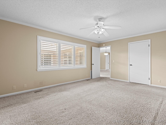 1525 Pecan Pl, Bartlesville, OK 74003 - unfurnished bedroom featuring ornamental molding, a textured ceiling, carpet, and a ceiling fan