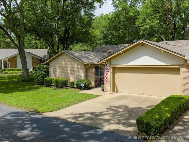 1525 Pecan Pl, Bartlesville, OK 74003 - view of front of property featuring brick siding, driveway, a garage, and a front yard