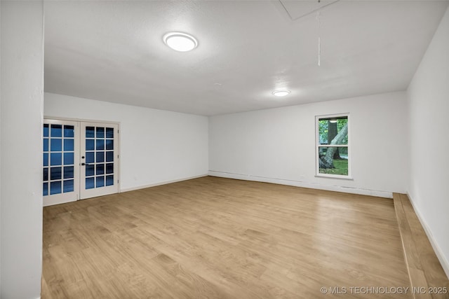 4235 E 104th St, Tulsa, OK 74137 - spare room featuring french doors, wood finished floors, and attic access