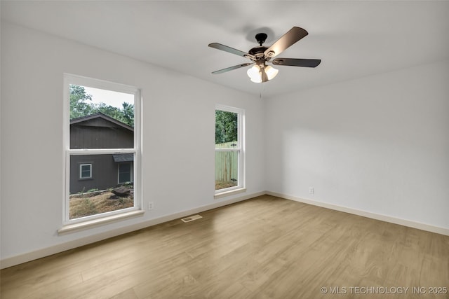 4235 E 104th St, Tulsa, OK 74137 - spare room featuring plenty of natural light, wood finished floors, and ceiling fan