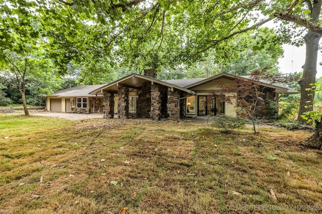 4235 E 104th St, Tulsa, OK 74137 - view of front of home featuring a chimney, stone siding, a garage, and a front yard