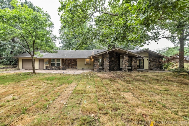 4235 E 104th St, Tulsa, OK 74137 - view of front of house featuring stone siding, a garage, a front yard, and concrete driveway