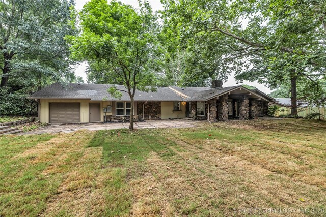 4235 E 104th St, Tulsa, OK 74137 - rear view of house with a garage, stone siding, a chimney, and a yard