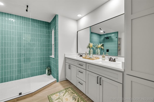 4235 E 104th St, Tulsa, OK 74137 - bathroom with double vanity, a walk in shower, and wood finished floors