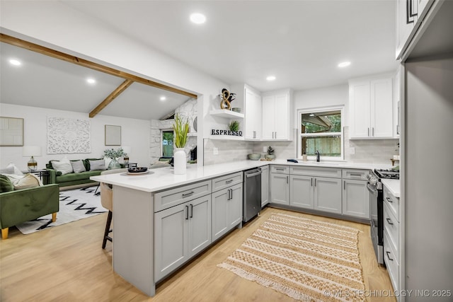 4235 E 104th St, Tulsa, OK 74137 - kitchen with stainless steel appliances, decorative backsplash, gray cabinetry, a kitchen bar, and recessed lighting