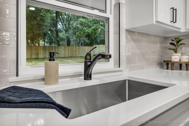 4235 E 104th St, Tulsa, OK 74137 - kitchen view of tasteful backsplash, white cabinets, and light countertops