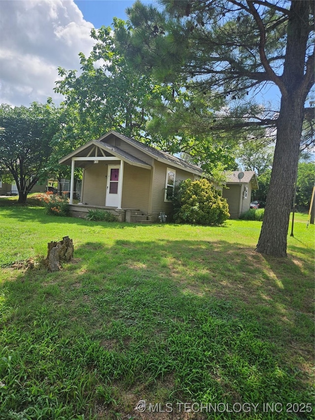 307 N Hartman Ave, Cushing, OK 74023 - view of grassy yard with covered porch