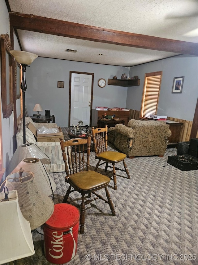 307 N Hartman Ave, Cushing, OK 74023 - carpeted living area featuring beam ceiling and wainscoting