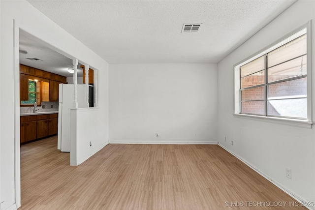 3344 S 120th E Ave, Tulsa, OK 74146 - unfurnished room featuring a textured ceiling and light wood-type flooring
