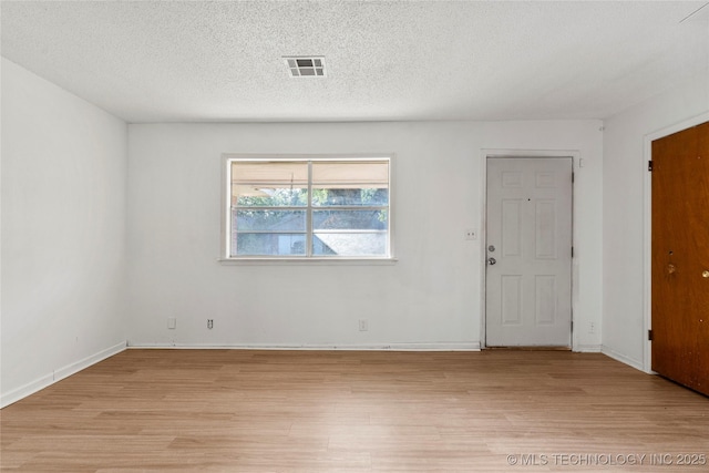 3344 S 120th E Ave, Tulsa, OK 74146 - unfurnished room featuring light wood-style floors and a textured ceiling